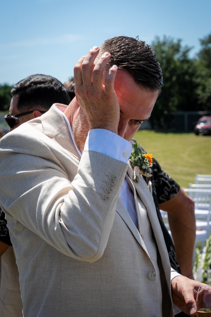 Emotional candid moment for a groom during the outdoor ceremony