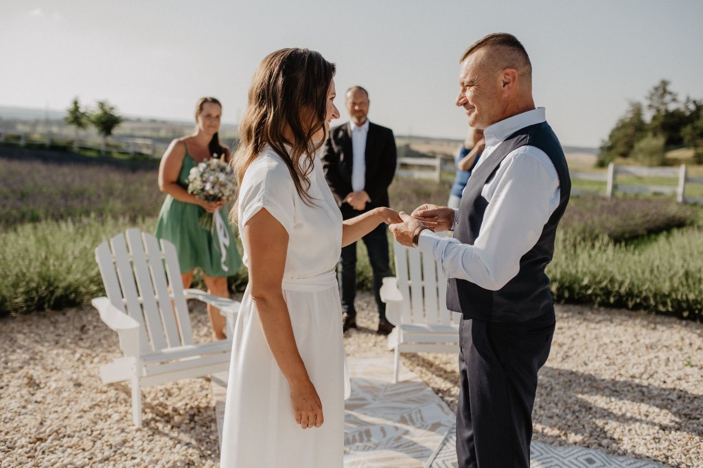 Ring exchange during an outdoor ceremony by the lavender field