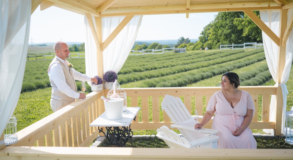 Bride and groom at the gazebo overlooking the lavender rows