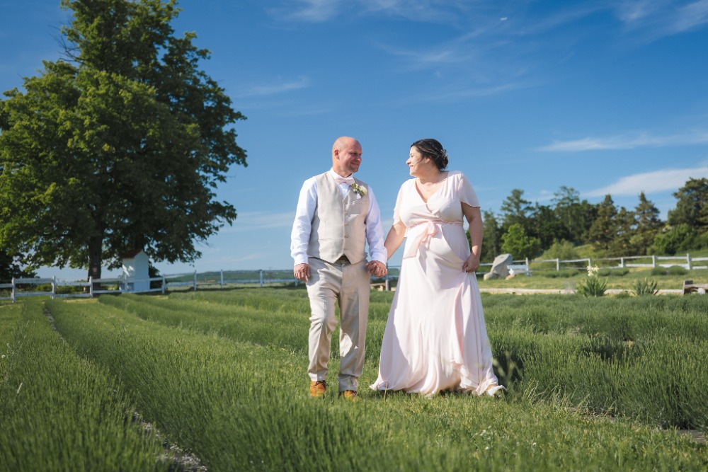 Hand in hand walking through the lavender field