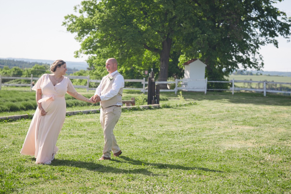 Walking together across the lawn by the fence and wayside shrine