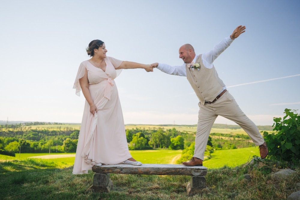 Playful pose on a wooden bench above the valley