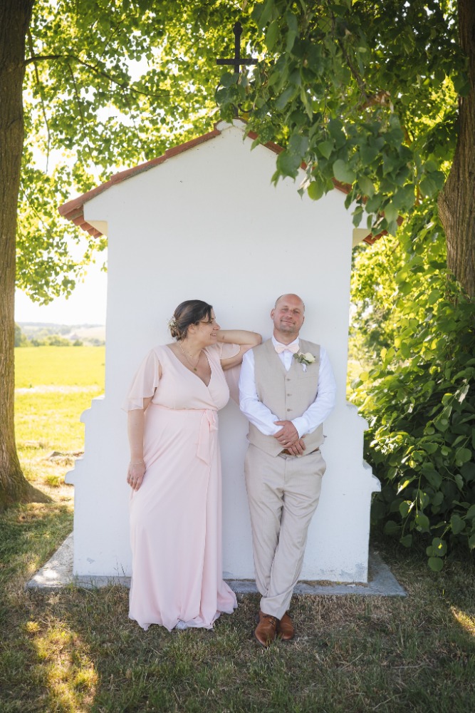 Portrait by a small chapel under the trees